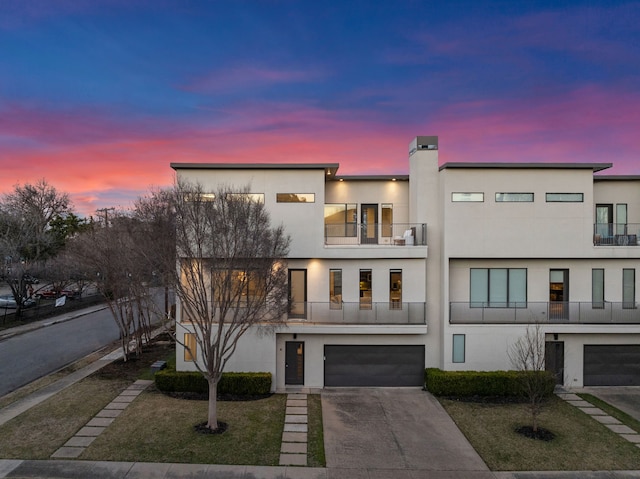 view of front of home featuring a garage and a balcony