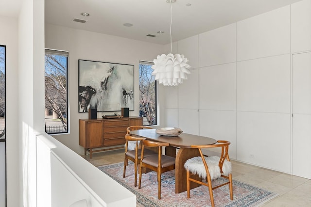 dining space featuring plenty of natural light and light tile patterned floors