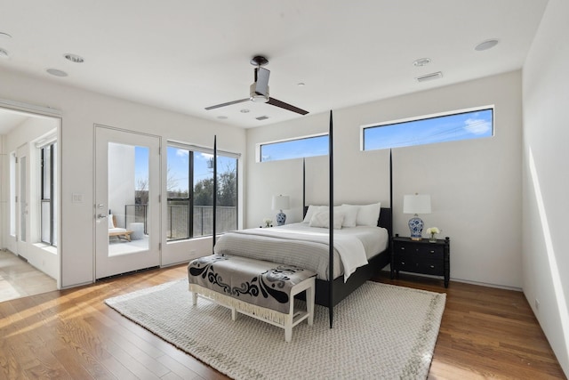 bedroom with ceiling fan, wood-type flooring, and access to exterior