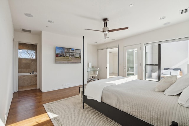 bedroom featuring connected bathroom, hardwood / wood-style floors, and ceiling fan