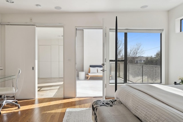 bedroom featuring two closets and light hardwood / wood-style floors