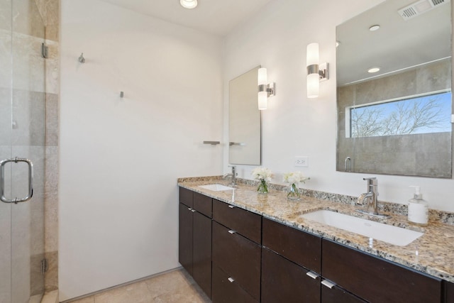 bathroom featuring vanity and an enclosed shower