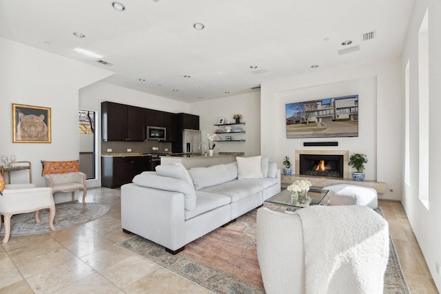 living room with sink and light tile patterned flooring