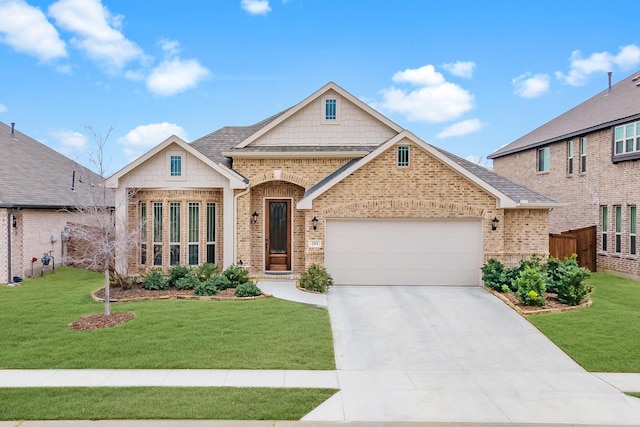 view of front of property featuring an attached garage, a front yard, and brick siding