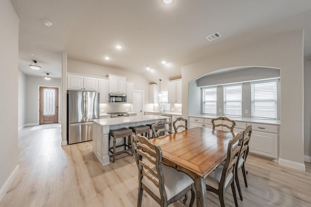 dining area with a healthy amount of sunlight, visible vents, and light wood-style flooring