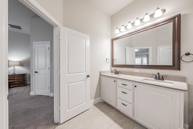 full bath with double vanity, a sink, visible vents, and baseboards