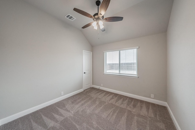 unfurnished room with lofted ceiling, visible vents, a ceiling fan, carpet flooring, and baseboards