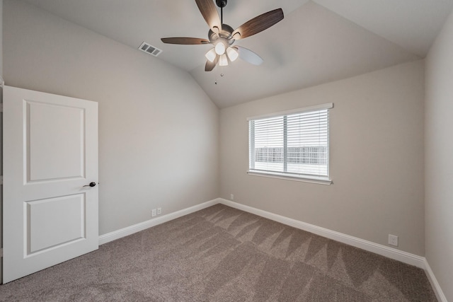 spare room with carpet, lofted ceiling, visible vents, ceiling fan, and baseboards