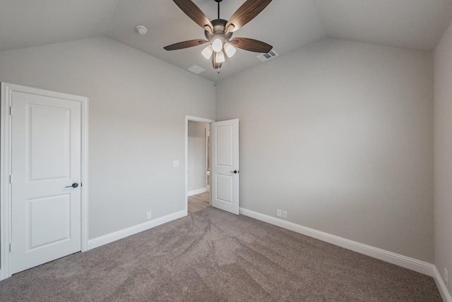 unfurnished bedroom with lofted ceiling, carpet, visible vents, and baseboards