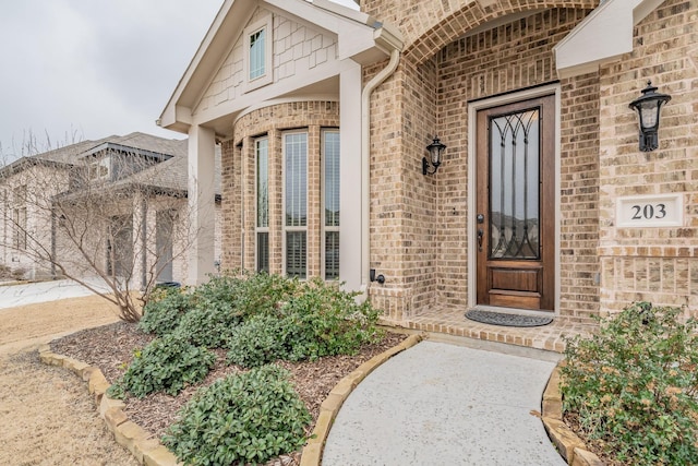 property entrance with brick siding