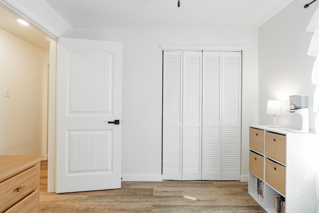 unfurnished bedroom with a closet and light hardwood / wood-style flooring