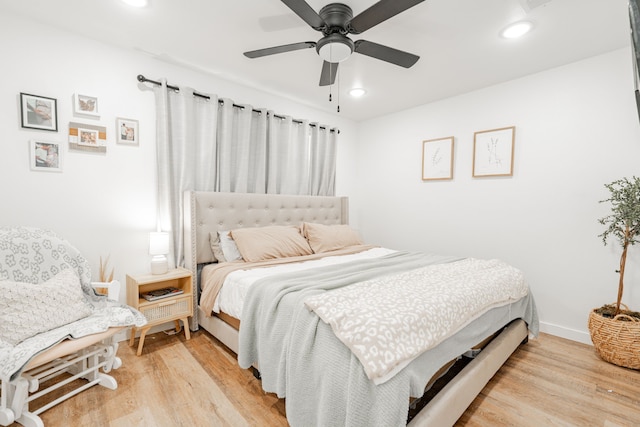 bedroom with ceiling fan and light wood-type flooring