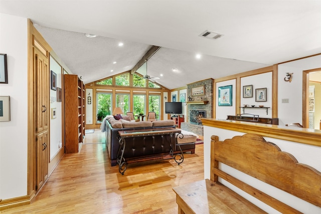 living room with ceiling fan, high vaulted ceiling, a brick fireplace, beamed ceiling, and light wood-type flooring