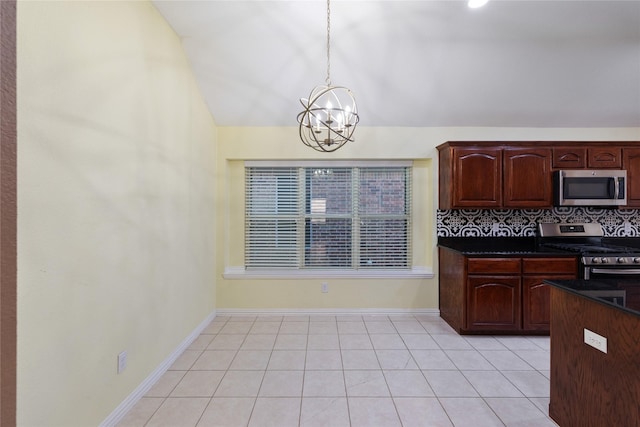 kitchen featuring light tile patterned flooring, appliances with stainless steel finishes, decorative backsplash, hanging light fixtures, and a notable chandelier