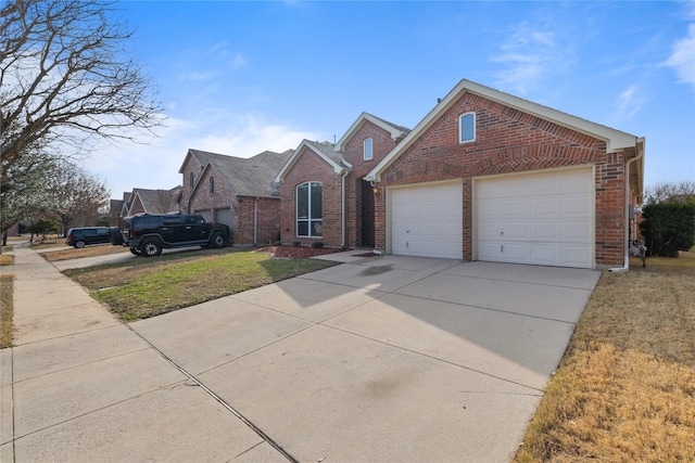 front facade featuring a garage and a front lawn