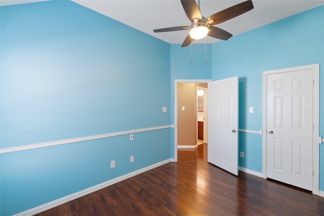 unfurnished bedroom with dark wood-type flooring and ceiling fan