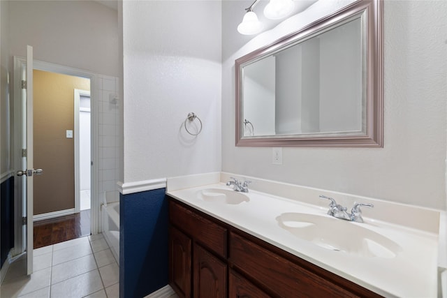 bathroom featuring tile patterned floors,  shower combination, and vanity