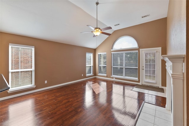 unfurnished living room featuring vaulted ceiling, light hardwood / wood-style floors, and ceiling fan