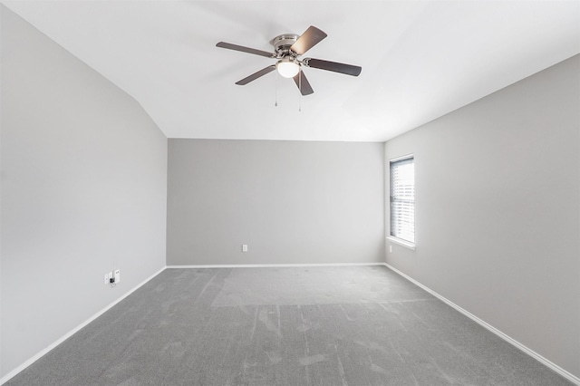 carpeted empty room featuring vaulted ceiling and ceiling fan