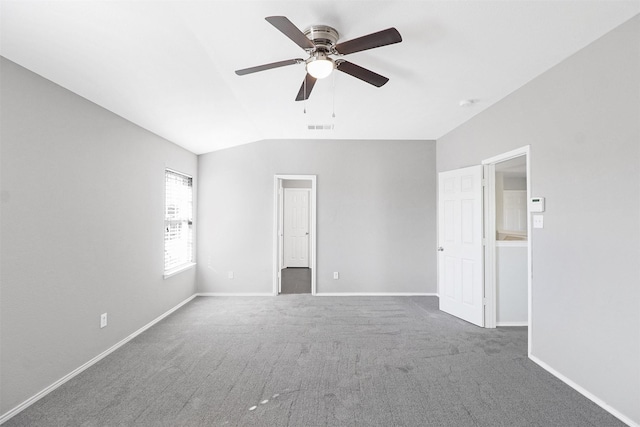 carpeted empty room with lofted ceiling and ceiling fan