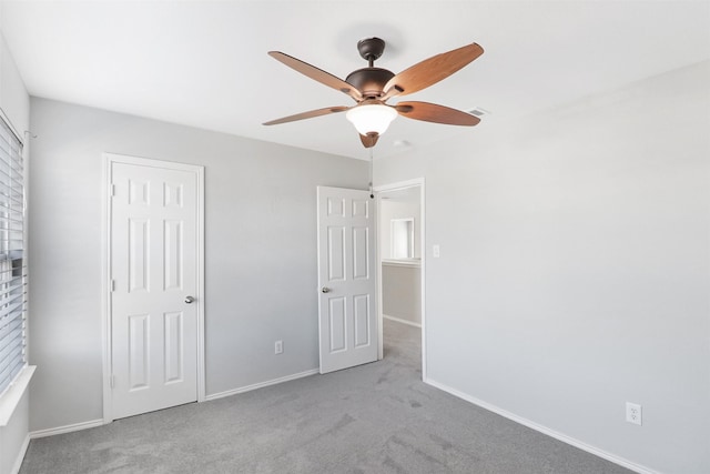 unfurnished bedroom with light carpet and ceiling fan