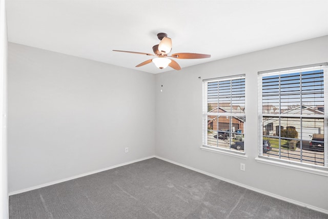 carpeted empty room featuring ceiling fan