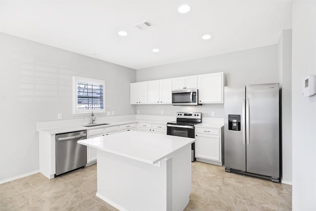 kitchen featuring white cabinetry, stainless steel appliances, sink, and a kitchen island