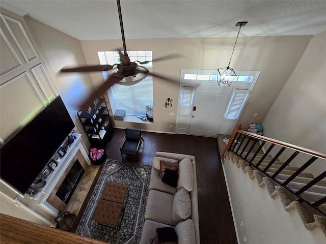 living room with a tile fireplace, hardwood / wood-style floors, and ceiling fan