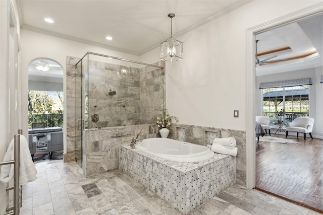 bathroom with ceiling fan with notable chandelier, ornamental molding, and plus walk in shower