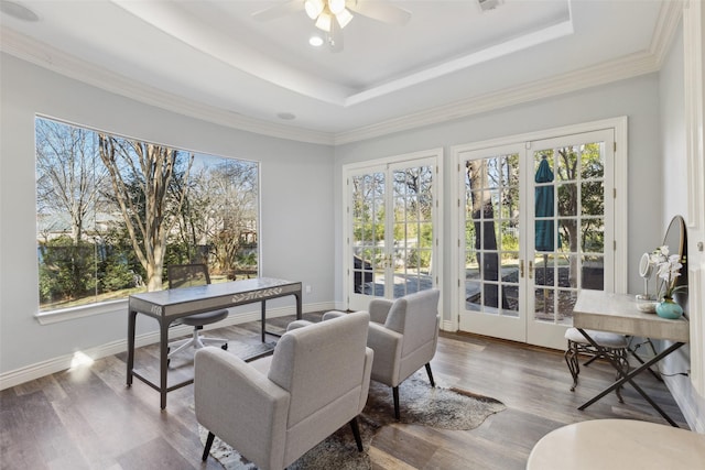 sitting room with french doors, ceiling fan, a tray ceiling, and hardwood / wood-style floors