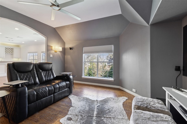 cinema room with hardwood / wood-style flooring, ceiling fan, and lofted ceiling