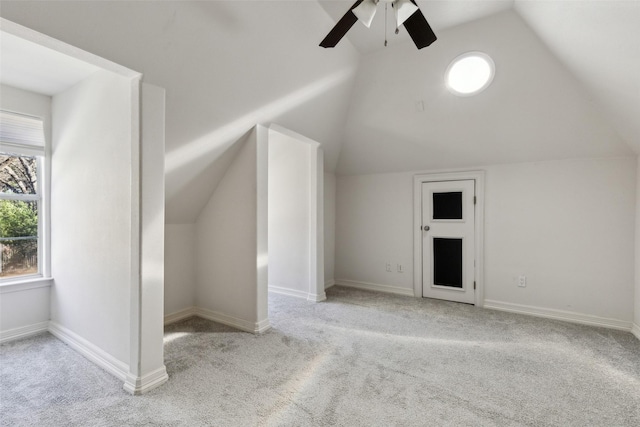 bonus room with ceiling fan, vaulted ceiling, and light carpet