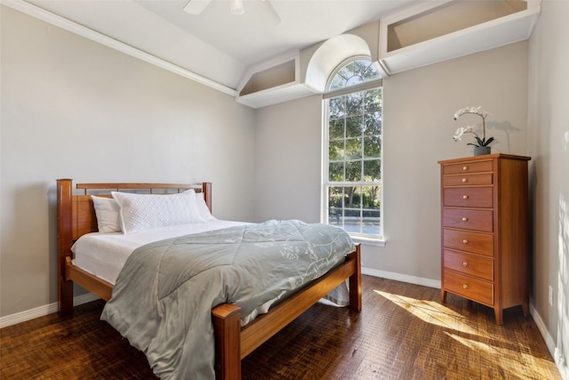 bedroom with ceiling fan, dark hardwood / wood-style flooring, and vaulted ceiling