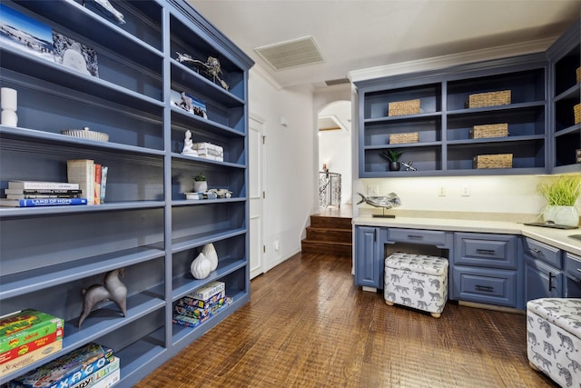 office area featuring crown molding and built in desk