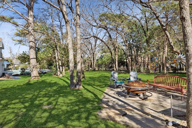 view of yard with a patio and an outdoor fire pit