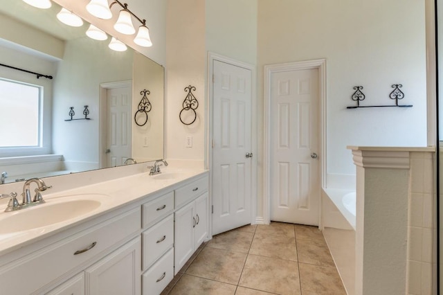 bathroom featuring vanity, a bath, and tile patterned flooring