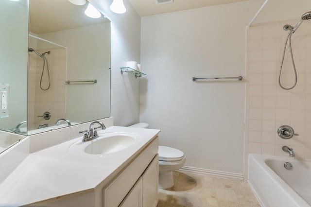 full bathroom featuring tiled shower / bath combo, vanity, and toilet