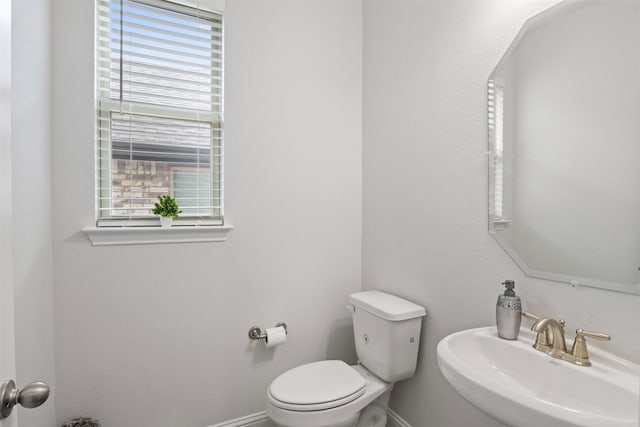 bathroom featuring toilet and sink