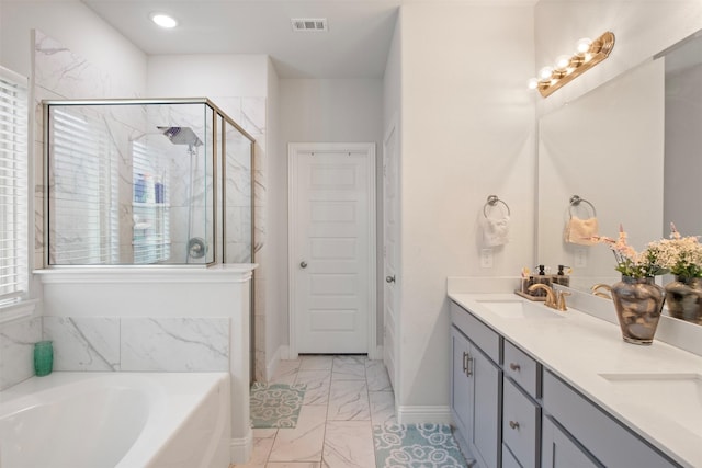 bathroom with vanity and separate shower and tub