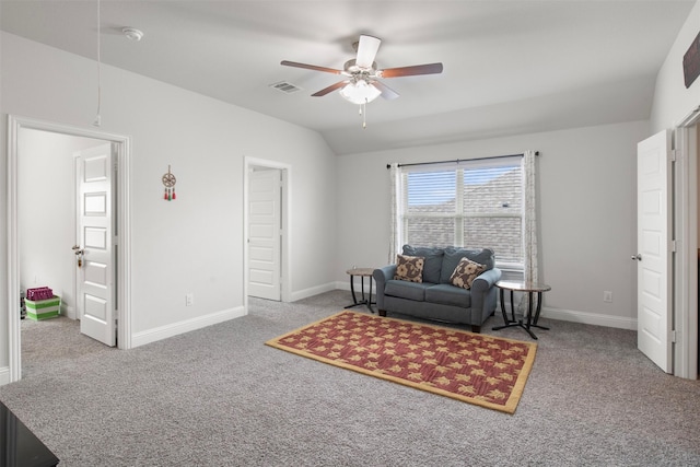 sitting room featuring ceiling fan, vaulted ceiling, and light carpet