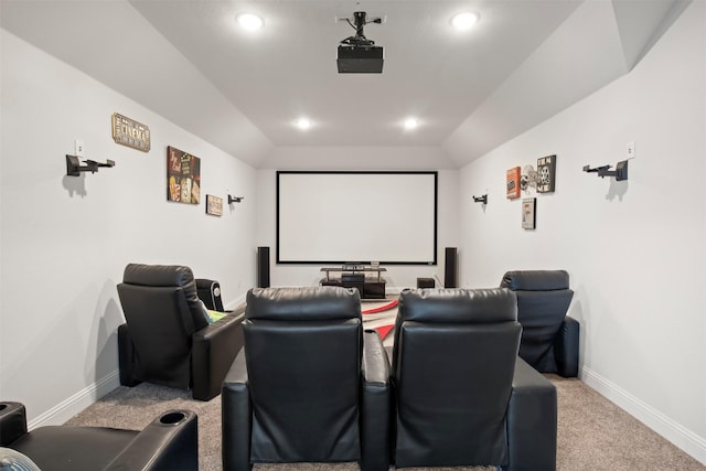 cinema featuring vaulted ceiling and carpet flooring