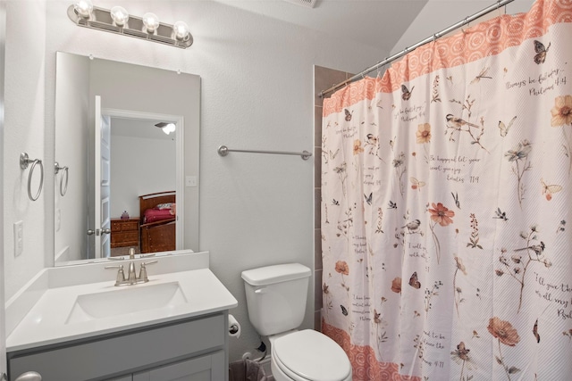 bathroom with vanity, toilet, and walk in shower