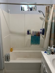 bathroom featuring vanity and shower / tub combo with curtain