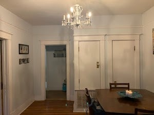 unfurnished dining area with dark hardwood / wood-style flooring and a chandelier