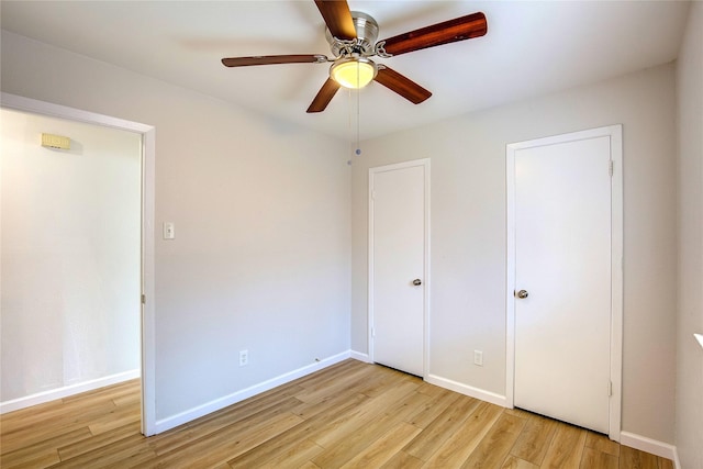 unfurnished bedroom featuring light wood-style floors, baseboards, and a ceiling fan