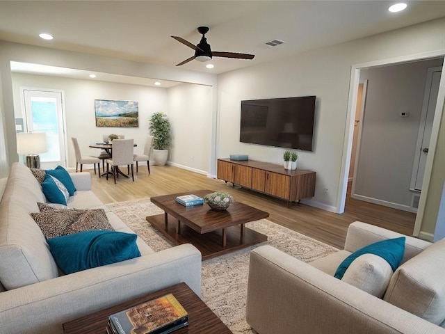 living area featuring ceiling fan, recessed lighting, wood finished floors, visible vents, and baseboards