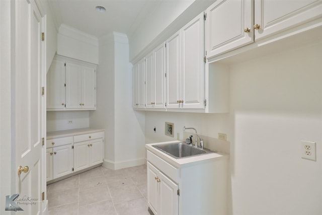 washroom with sink, crown molding, hookup for a washing machine, cabinets, and hookup for an electric dryer