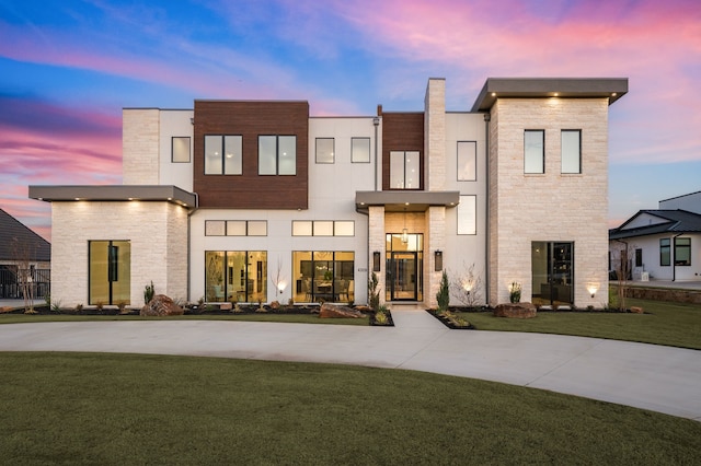 contemporary home featuring a yard