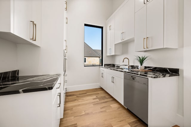 kitchen featuring white cabinetry, sink, light hardwood / wood-style flooring, and dishwasher