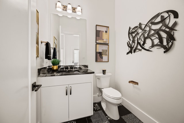 bathroom with tile patterned floors, vanity, and toilet